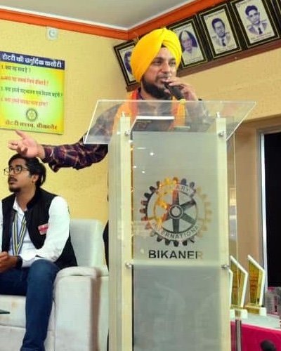 Dr. P. S. Vohra speaking at a lectern
