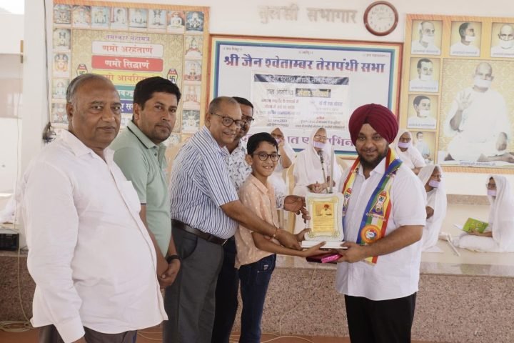 Presenting a trophy to a student at the Jain Shwetambar Terapanthi Sabha