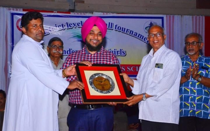 Receiving a plaque at a district-level school tournament
