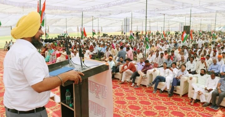 Addressing a pandal of several hundred under the tricolour